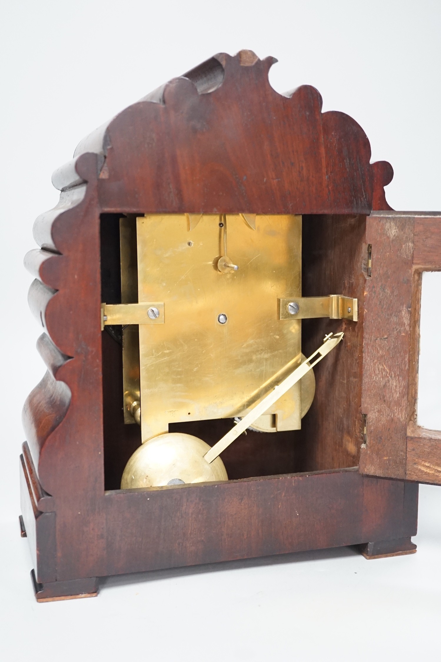 Mason, Ipswich. A 19th century mahogany cased mantel clock with scrolling moulded decoration - 31cm tall